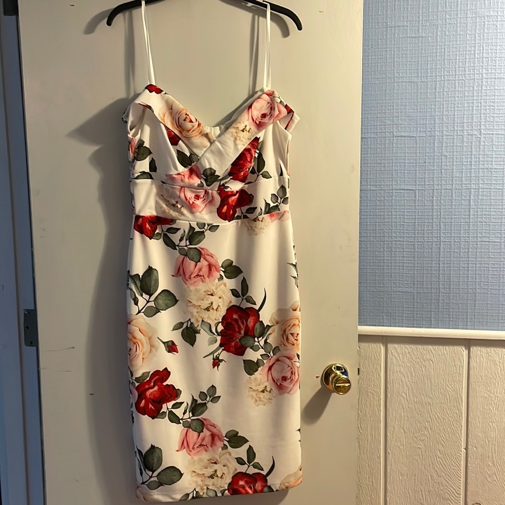 A floral white dress, it has off the shoulder sleeves, in good condition